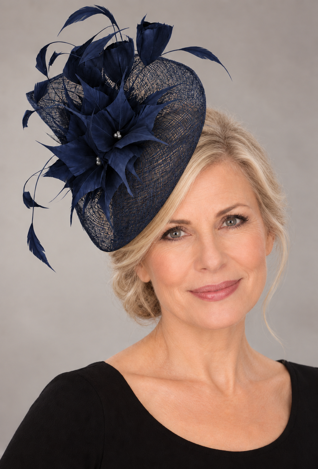 French navy sinamay fascinator on a mature blonde model