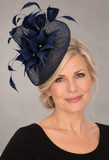 French navy sinamay fascinator on a mature blonde model