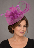 Fuchsia sinamay fascinator by Snoxell and Gwyther on a mature model