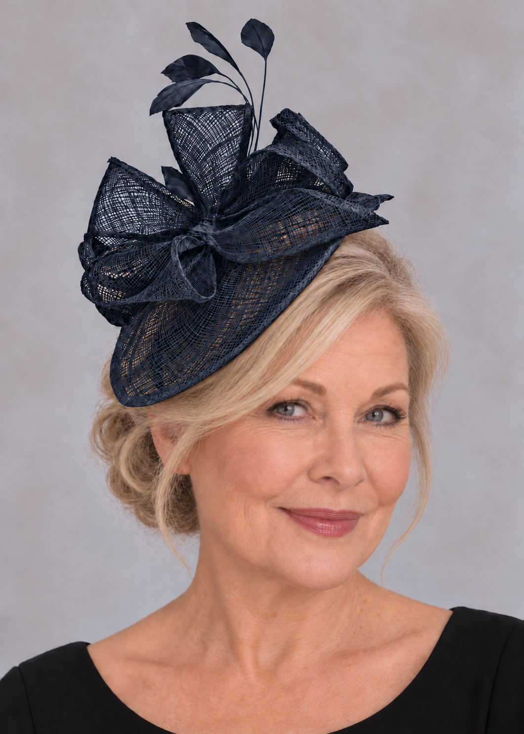 French navy sinamay fascinator worn by an elegant blonde model