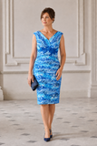 Blue and white wedding guest dress with fitted knee-length silhouette and coordinating royal blue jacket