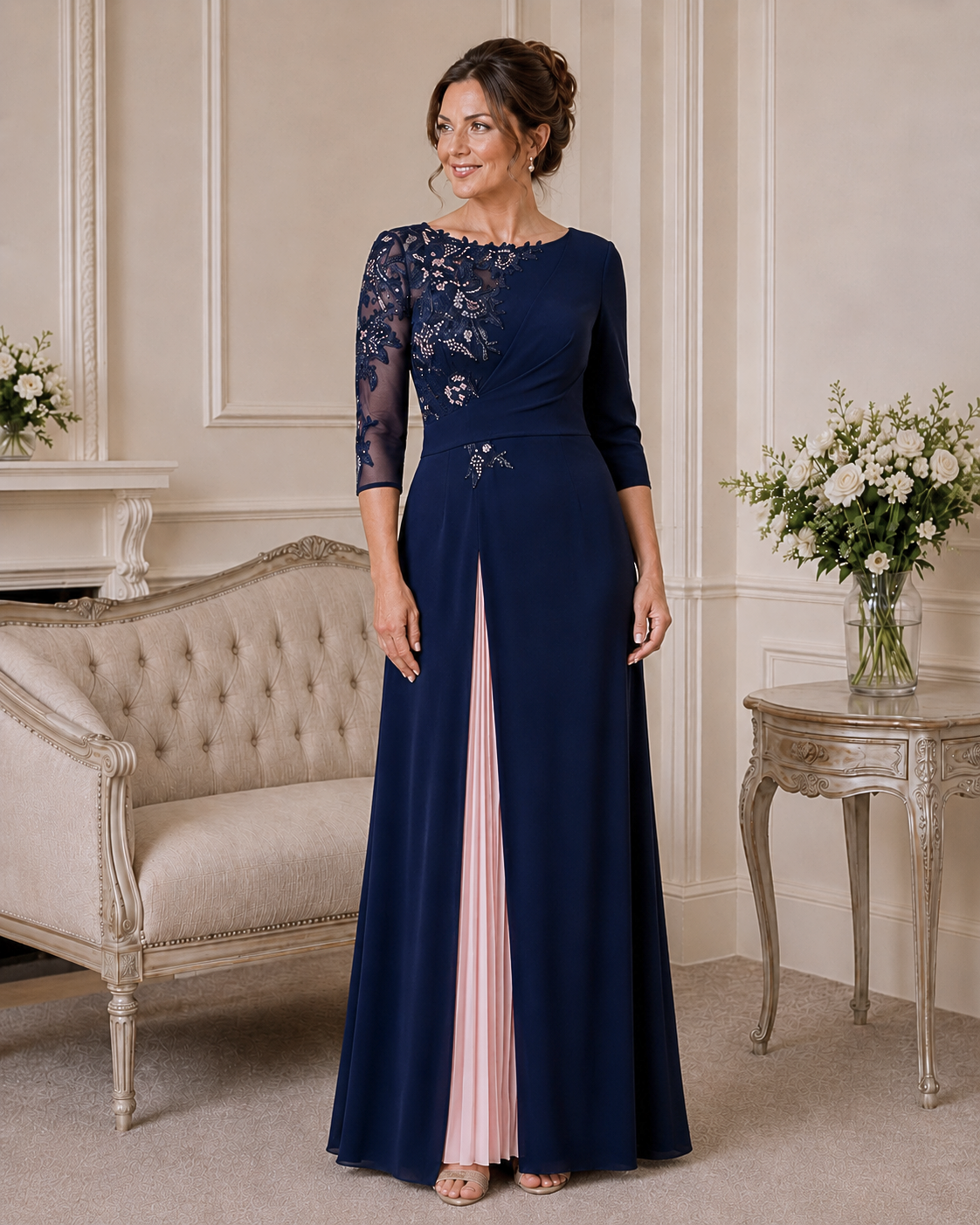 Navy mother of the bride gown with beaded lace bodice, three-quarter sleeves and blush pleated front panel