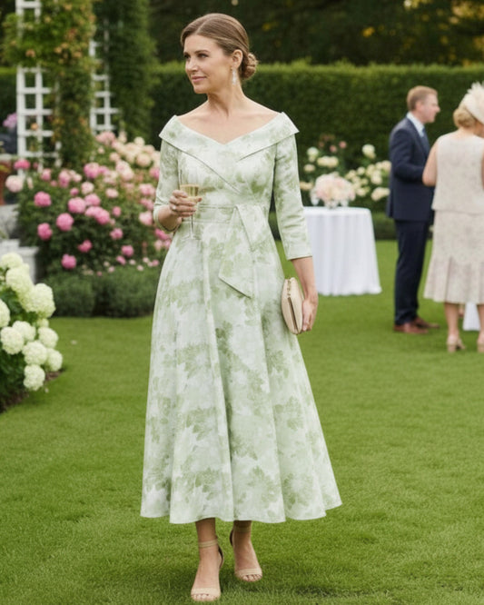 a mint brocade midi length dress with a v neckline and 3/4 sleeves for a mother of the groom