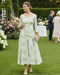 a mint brocade midi length dress with a v neckline and 3/4 sleeves for a mother of the groom