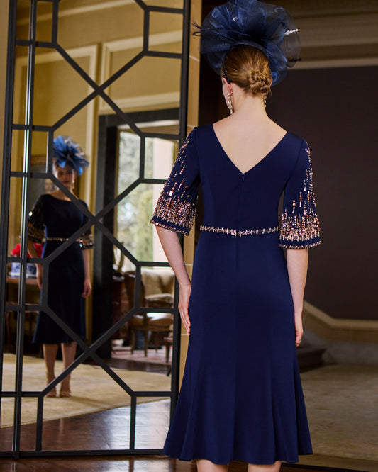 back view of an Elegant midi evening dress with boat neckline and three-quarter sleeves