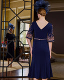 back view of an Elegant midi evening dress with boat neckline and three-quarter sleeves