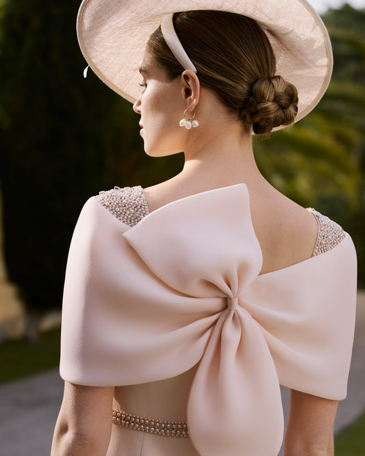 Back view of soft peach pink Couture Club midi occasion dress with statement organza bow detail
