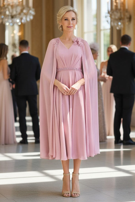 Blush pink chiffon mother of the bride midi dress with attached cape and beaded waist