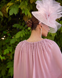Back view of blush pink chiffon occasion dress with cape and beaded neckline for mother of the bride