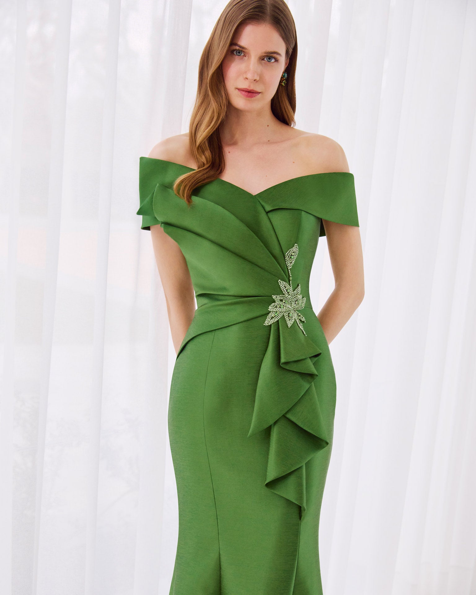 Green off-shoulder gown with embellishments on the waist for a formal wedding