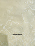 Close-up of buttery cream brocade dress fabric featuring metallic gold thread and subtle floral pattern