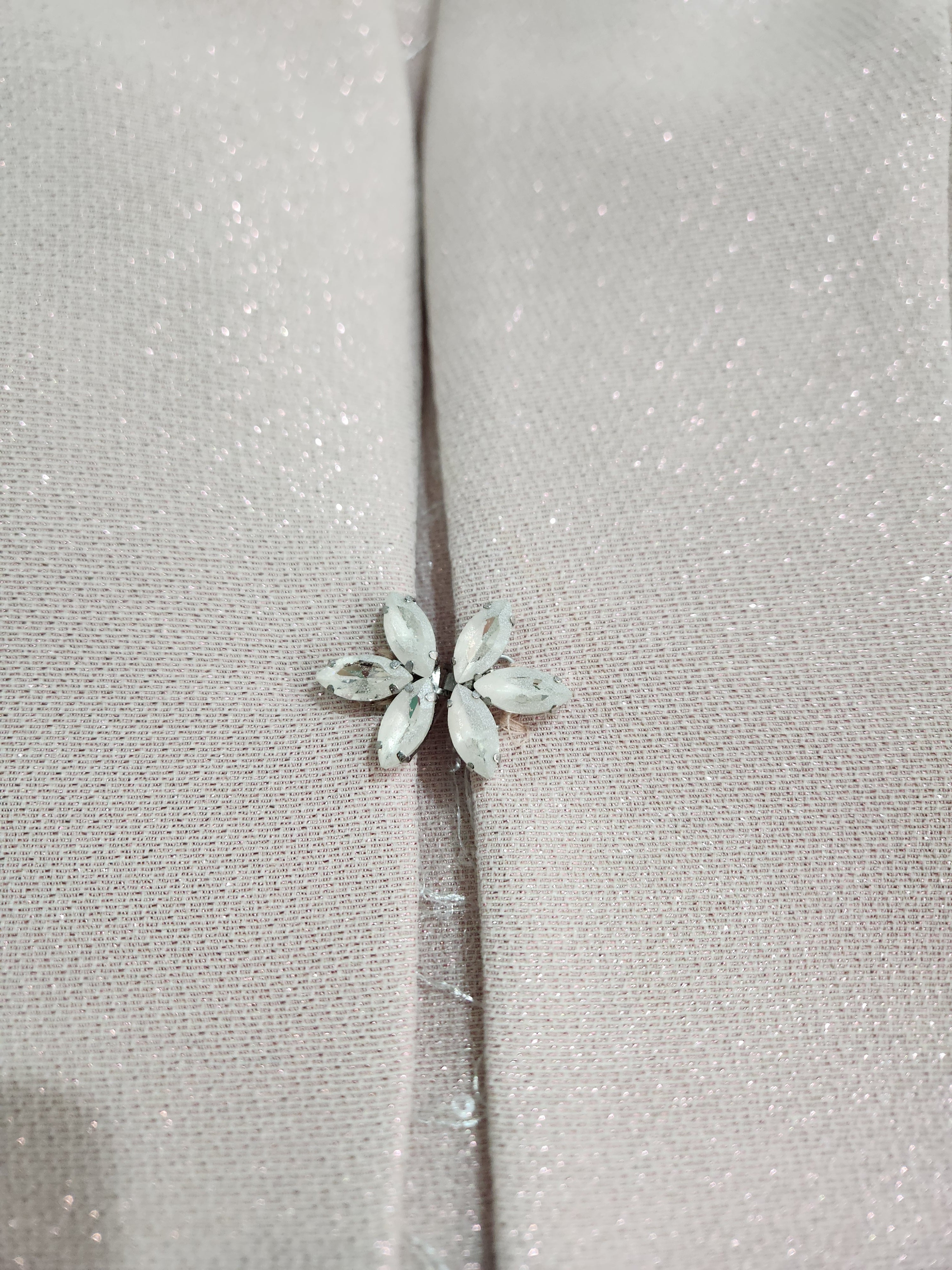 Clasp detail of the jacket on the mother of the bride dress and jacket from Sonia Pena, available in Melbourne.