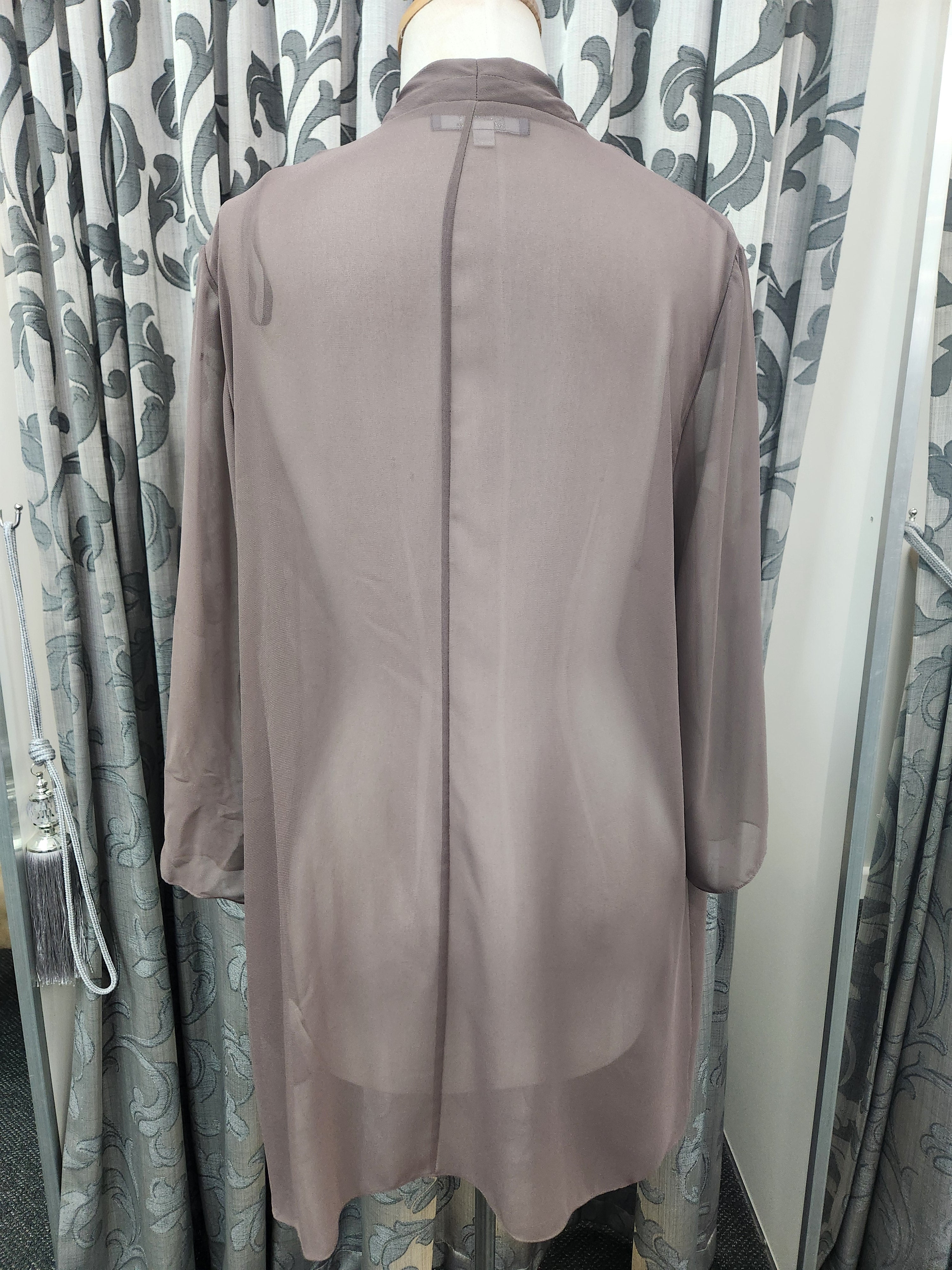 Back view of tan three-quarter sleeve occasion jacket on mannequin