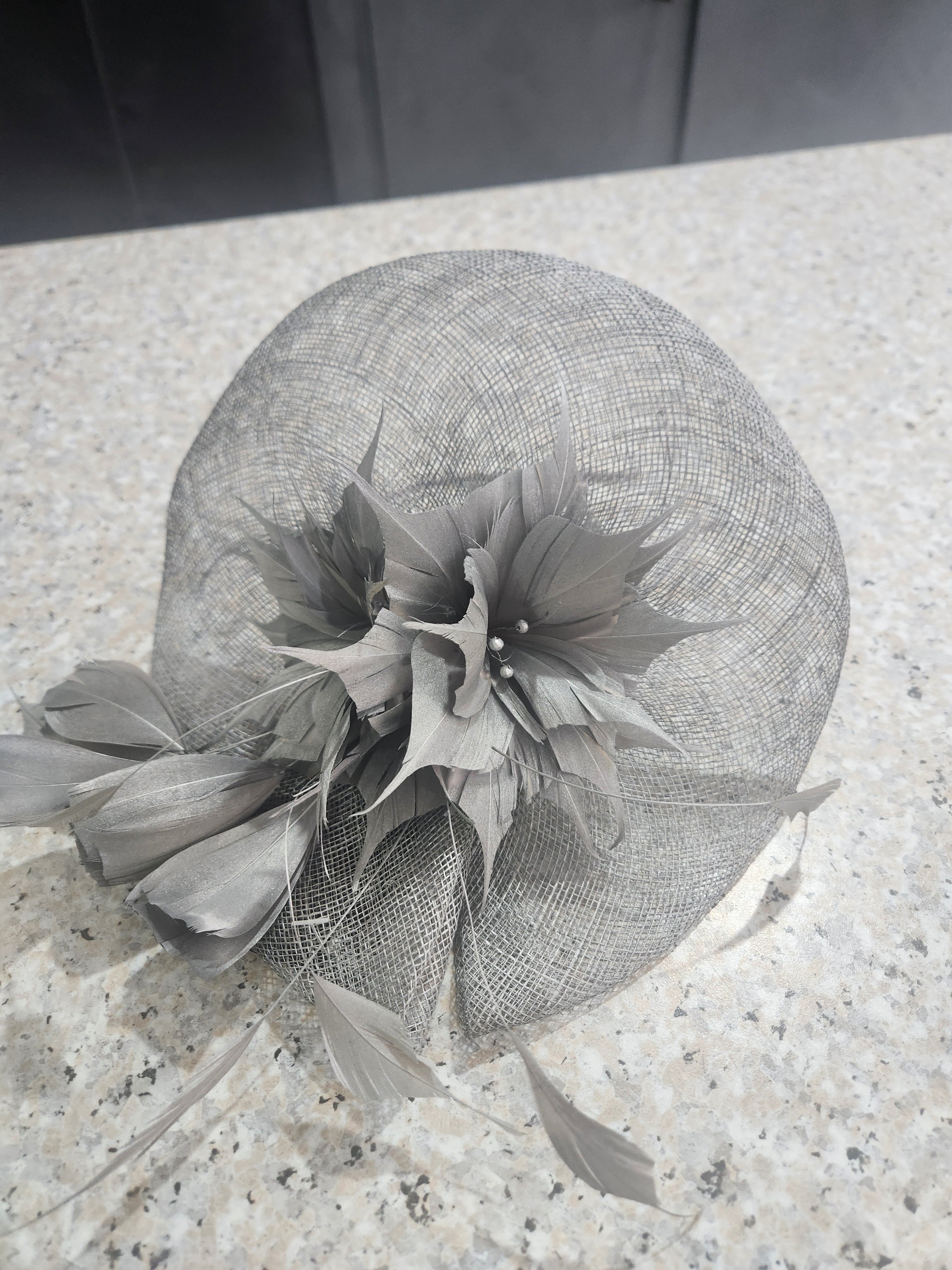 Silver occasion fascinator with open weave and feather flowers
