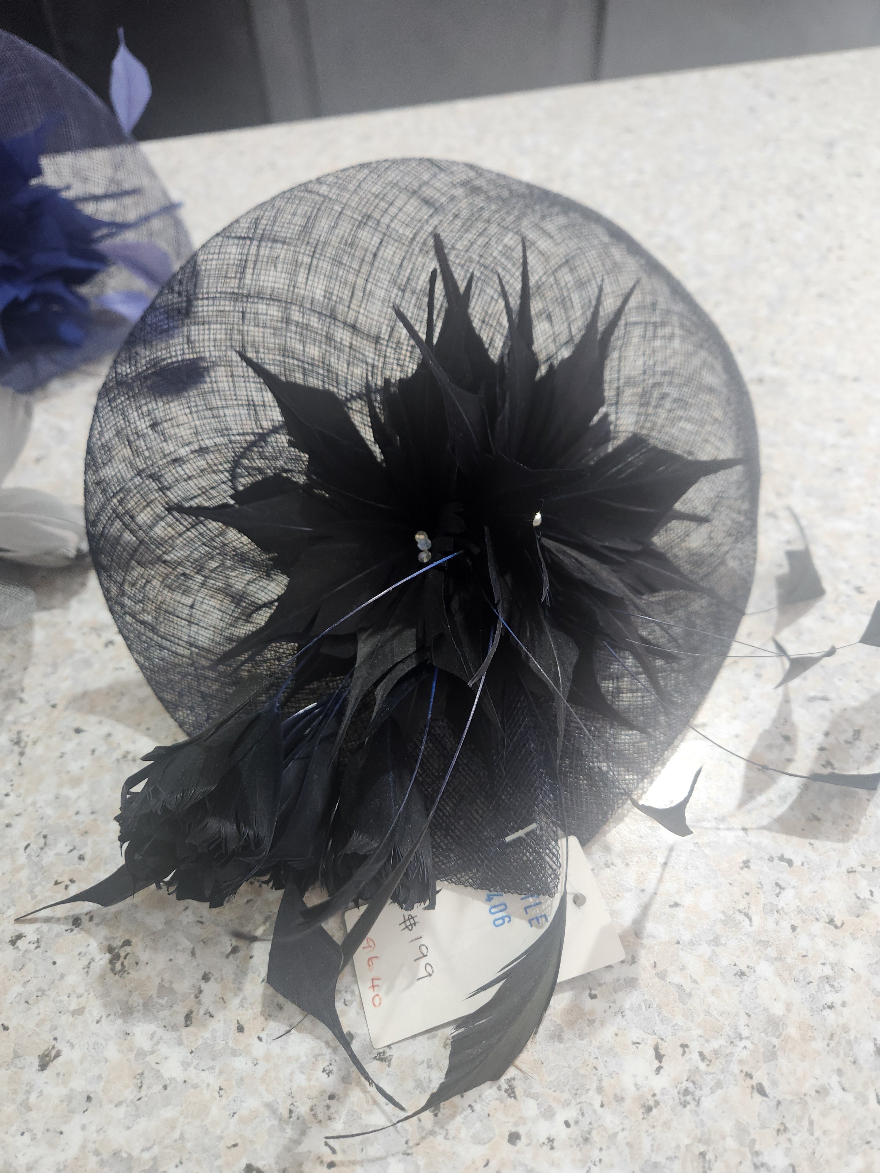 Very dark navy fascinator with feather flowers and pearl accents