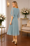 Rear view of light teal chiffon occasion dress by Lizabella showcasing elegant drape and feminine A-line shape
