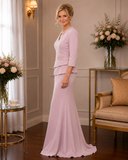 Side profile of dusty pink crepe evening gown with flattering peplum detail and fitted silhouette in luxury boutique setting