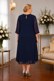 Back view of plus size navy mother of the bride dress featuring floaty chiffon overlay and elegant silhouette