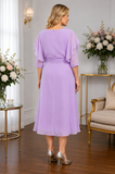 Back view of Lizabella lilac chiffon occasion dress with flowing silhouette and waist detail