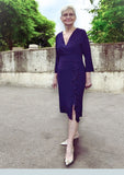 Flattering jersey occasion dress with frill to the hem and feather brooch