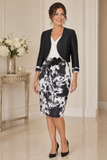 Black and white wedding guest dress with ruched white bodice, floral waist embellishment and elegant knee-length silhouette