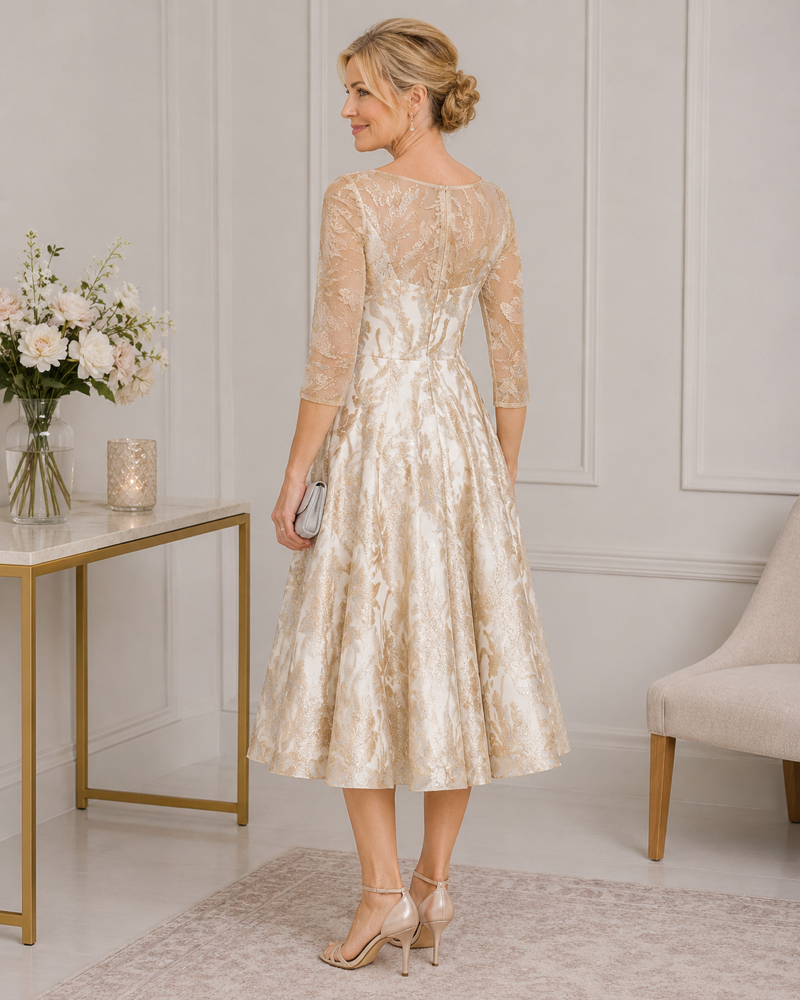 Back view of ivory and gold floral jacquard mother of the bride dress featuring illusion lace sleeves, fitted waist and elegant full skirt.