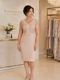 Elegant taupe occasion dress with lace bodice, cap sleeves and bow waist detail.