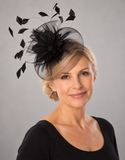 Black crinoline fascinator worn by a mature blonde model