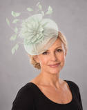 Soft mint crinoline fascinator worn by a mature blonde model