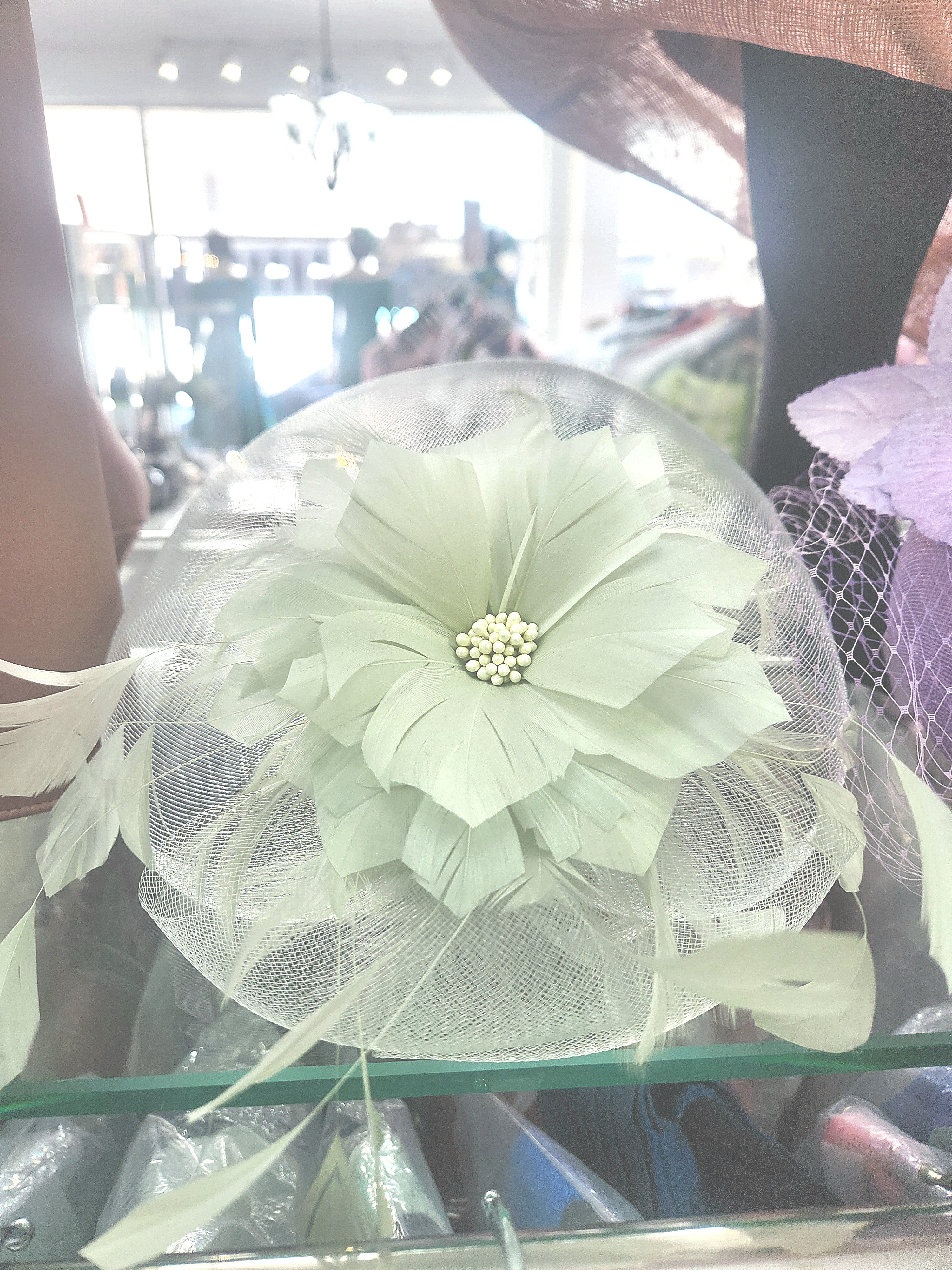 Pale mint wedding fascinator with a layered feather flower