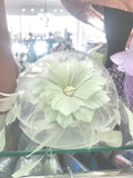 Pale mint wedding fascinator with a layered feather flower