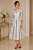 Silver Couture Club mother of the bride dress with lace sleeves and tea-length skirt