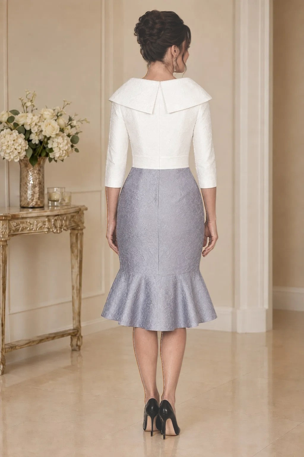 Elegant mother of the groom dress in ivory and silver grey with three-quarter sleeves and fitted jacquard skirt