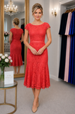 Coral lace mother of the bride dress with cap sleeves and fluted hem, shown on a size 12–14 model with formal updo hairstyle in the Ever Elegant Melbourne boutique.