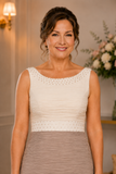 Close-up of taupe and ivory dress showing the beaded neckline, waist detail and softly ruched bodice