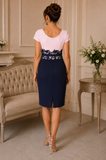 Back view of pink and navy Condici mother of the bride dress showing lace waist detail and back skirt vent