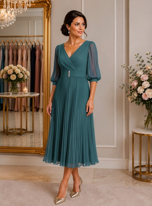 Teal blue pleated midi dress with sheer three-quarter sleeves and flattering waist detail