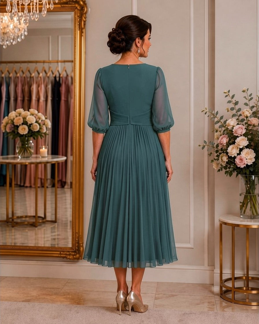 Elegant teal occasion dress with flowing pleated skirt, ideal for mother of the bride or groom