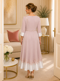Elegant blush pink wedding guest dress with embroidered shoulder detail, flowing tea-length skirt and back view styling for mature women