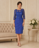 Royal blue lace mother of the bride dress with three-quarter sleeves and layered knee-length skirt.