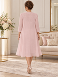 Back view of blush pink mother of the bride dress and chiffon coat with sheer lace detail and flowing silhouette