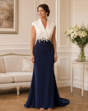 Couture Club 7G110 navy and cream mother of the bride gown on brunette model in elegant indoor setting
