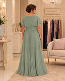 Back view of aqua teal chiffon evening gown with ruched waist and flowing pleated skirt.