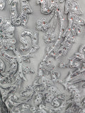 close up of the silver lace  on the bodice of a mother of the bride dress in chiffon and lace.