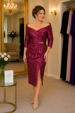 Veni Infantino fuchsia and red floral brocade mother of the bride dress with Bardot neckline, ruched detailing and side split, shown on a size 12–14 model in the Ever Elegant Melbourne boutique.