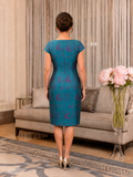 Back view of teal and magenta jacquard knee-length wedding occasion dress with cap sleeves