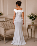 Back view of Veni Infantino silver and ivory formal gown showing beaded bodice, ivory neckline and full-length crepe skirt