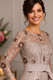 Close-up of champagne embellished lace mother of the bride dress showing floral appliqué, beaded embroidery, sheer neckline and elegant bodice details at Ever Elegant Melbourne.