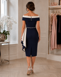 Back view of navy and ivory occasion dress with off-the-shoulder neckline, fitted skirt and two-tone crepe side panel.