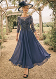 Light navy tea length mother of the bride dress with beaded lace bodice and chiffon skirt